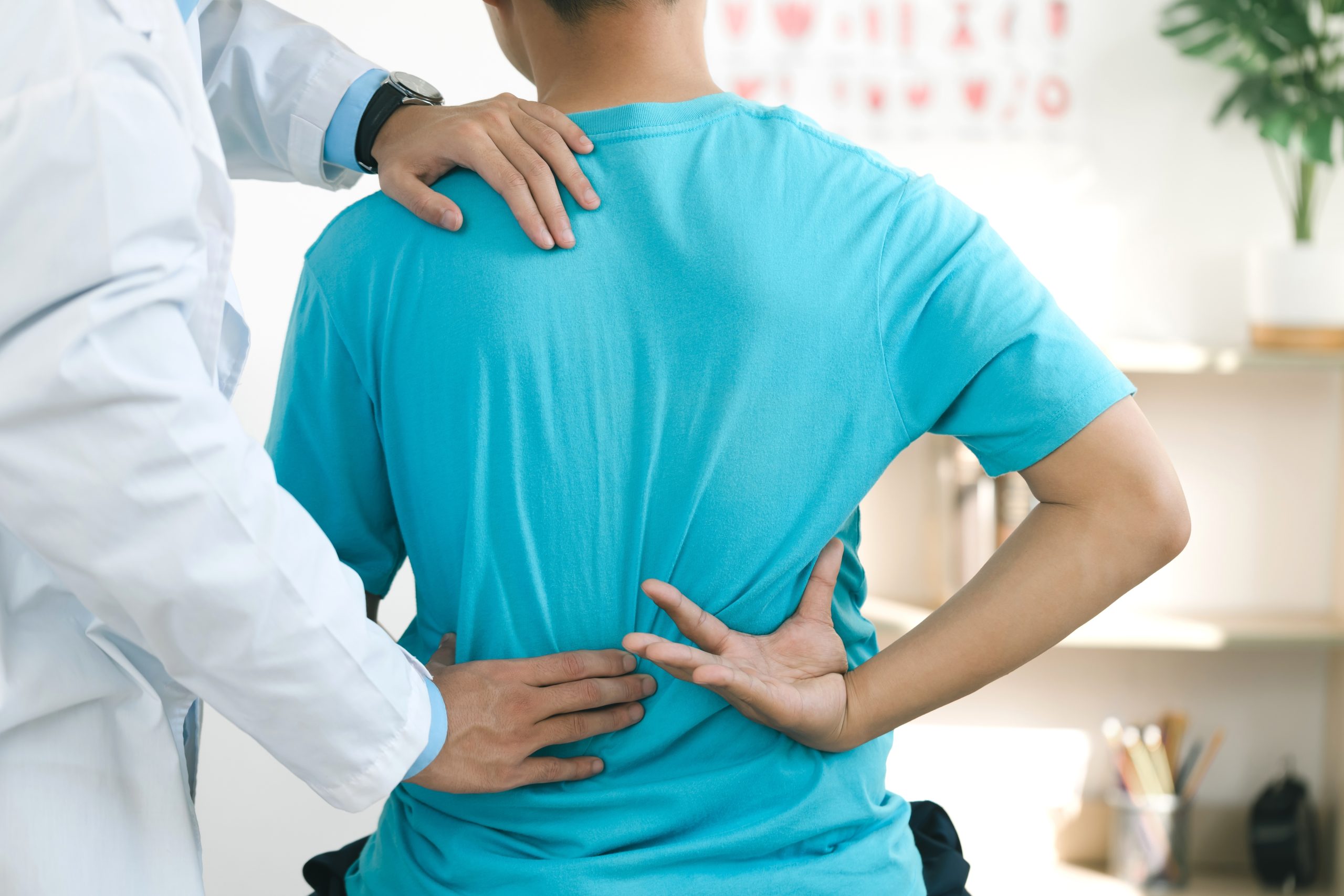Doctor,Physiotherapists,Treat,Lower,Back,Pain,In,Patients,In,The